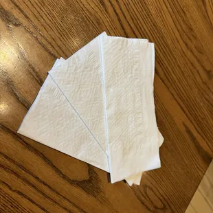 When the server brought extra napkins, he didn't just toss them on the table. He fanned them out with a flick of his wrist.