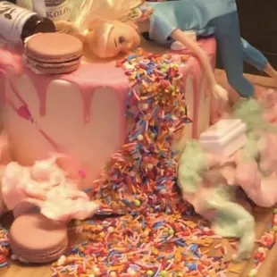 They supplied the cake w/ hot pink drip.  We supplied the decorations.   White cake w/ raspberry mousse filling. So good!