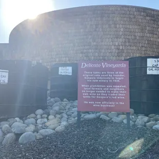 a sign in front of barrels