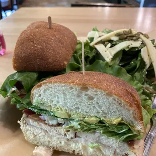 a sandwich and salad on a table