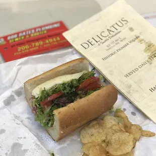 a sandwich and chips on a table