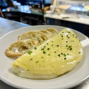 Golden omelette filled with melting cheese &amp; savory ham, made with organic eggs. A breakfast delight!