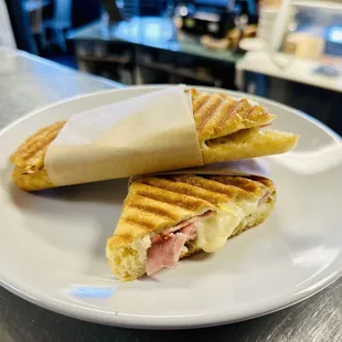 Buttered ham &amp; cheese panini, extra crispy. Indulge in the savory crunch!