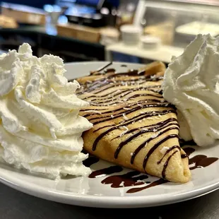 Banana, chocolate ganache &amp; coconut flakes crepe with homemade Chantilly. A tropical delight!