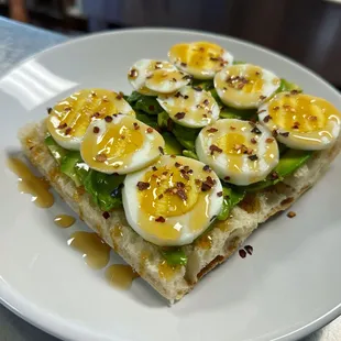 Avocado toast on our non gmo baguette with organic avo, eggs, honey &amp; red pepper flakes. Sweet &amp; spicy!&quot;