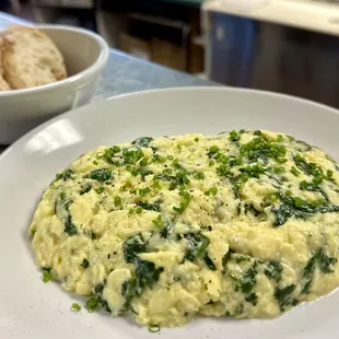 Scrambled eggs with organic creamed spinach: Rich, creamy, and nourishing. A gourmet start!