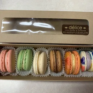 Half dozen variety pack of macarons: strawberry, pistachio, vanilla, chocolate, pumpkin spice and unicorn (left to right).