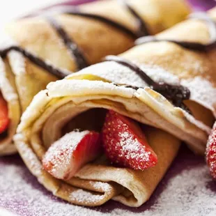 a plate of crepes with strawberries