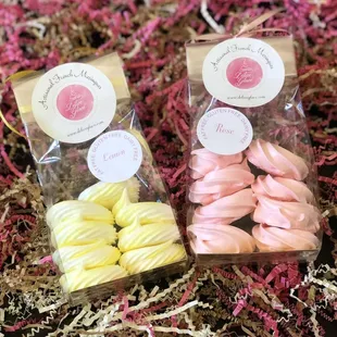 two bags of pink and yellow macarons
