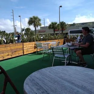 The outside patio has astro turf and a mix of wicker or metal chairs. Very cute.