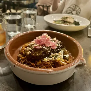 Birria short ribs with crispy adobo rice and pickled red onion.