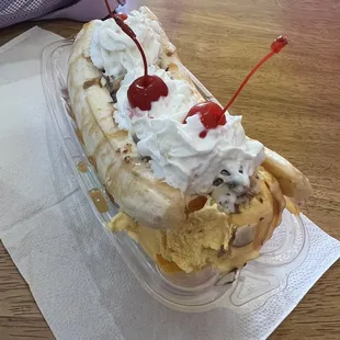 Banana split with a scoop of vanilla, cheese cream, pistachio ice cream.