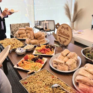 Volunteer lunch setup with sandwiches, fruit, strawberry salad, and pasta salad.