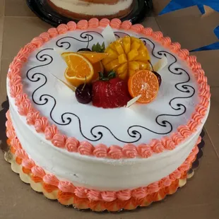 Our lemon cake with strawberry filling, butter cream frosting and decorated with carved fruit garnishes.
