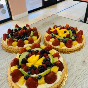 three fruit tarts on a table