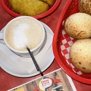 a bowl of potatoes and a cup of cappuccino