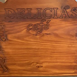 a wooden sign with a horse and rider