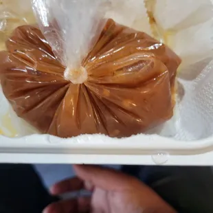 a person holding a plastic bag of food