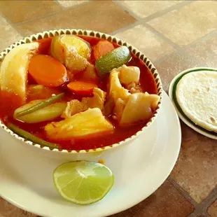 a bowl of soup and a tortilla