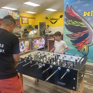 Foosball table, ice cream in the back