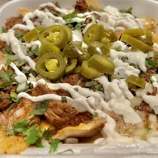 Birria Nachos. Similar to the Birria Quesadilla, but with warm tortilla chips, crema, and jalapeños added. Great meal on its own.