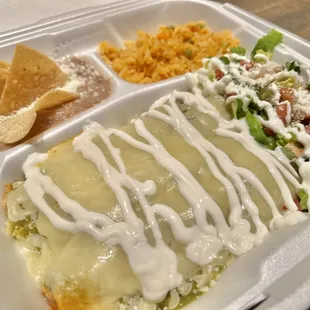 Chicken Enchiladas Plate. Shredded chicken with cheese &amp; green sauce; crema on top. Comes with a side salad, spanish rice, &amp; refried beans
