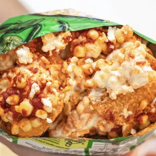 a hand holding a bag of food