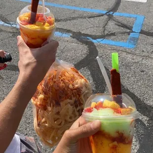 two people holding up drinks