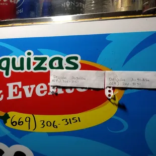 a piece of paper taped to a vending machine