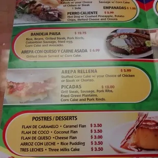 Skewers (chuzos) bandeja paisa, stuffed arepa, picada (food platter), and postres: desserts.. Flans or caramel and choco, tres..