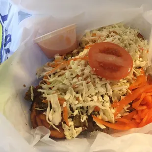 a sandwich with coleslaw and tomato