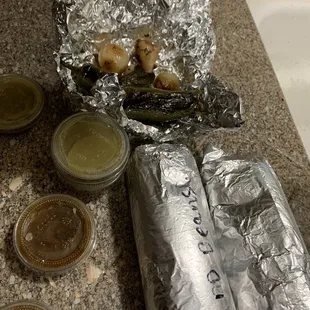 Two burritos, salsa, jalapeños, onions