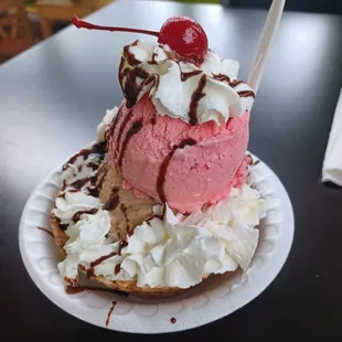 an ice cream sundae on a paper plate