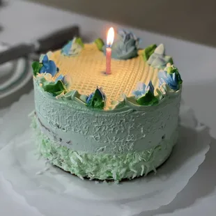 a cake with a lit candle