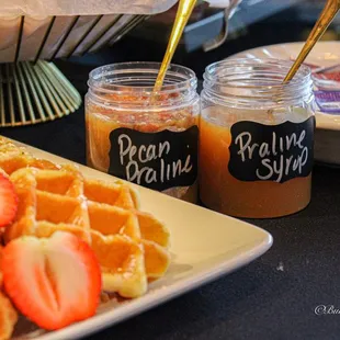 a plate of waffles and a jar of peanut butter