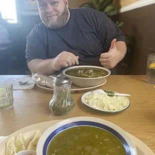Husband eating posole