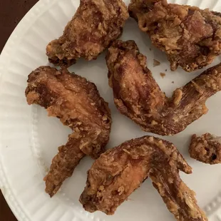 fried chicken wings on a paper plate