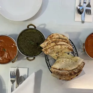 Butter Chicken (2x on the ends), Palak Paneer (middle), Garlic Cheese Naan