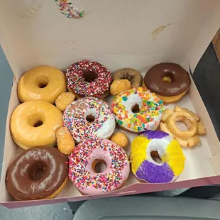 Dozen assorted donuts, minus one...someone couldn't wait.