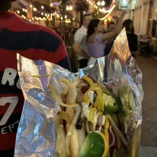 a person holding a hot dog