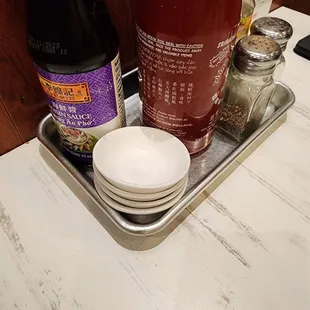 a tray of condiments and sauces