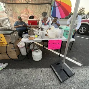 a group of people sitting under a tent