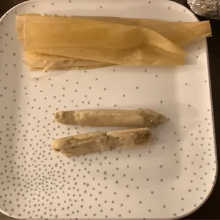 a couple of tamales on a plate