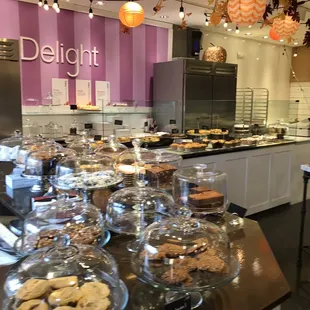 a counter of cookies and pastries