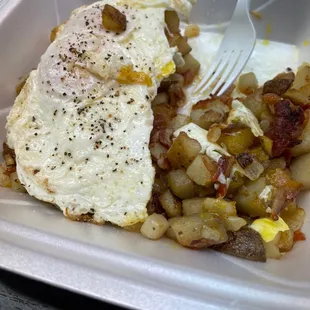 a plate of eggs and hash browns