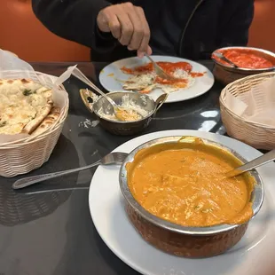 Butter chicken (red), spice paneer (yellow), basmati rice and garlic naan