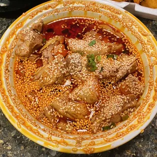 a bowl of chicken and sesame seeds