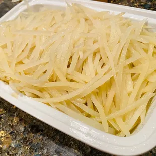 a plate of noodles on a granite countertop