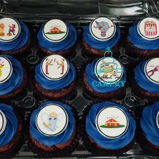 a tray of cupcakes with blue frosting