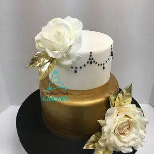 a white and gold wedding cake